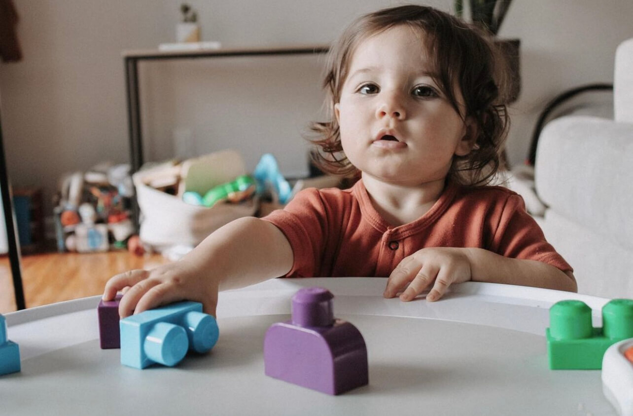 Baby girl playing with toys