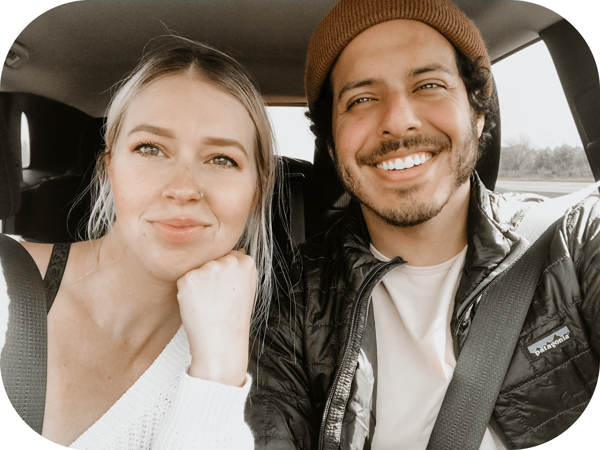 young couple smiling in a car