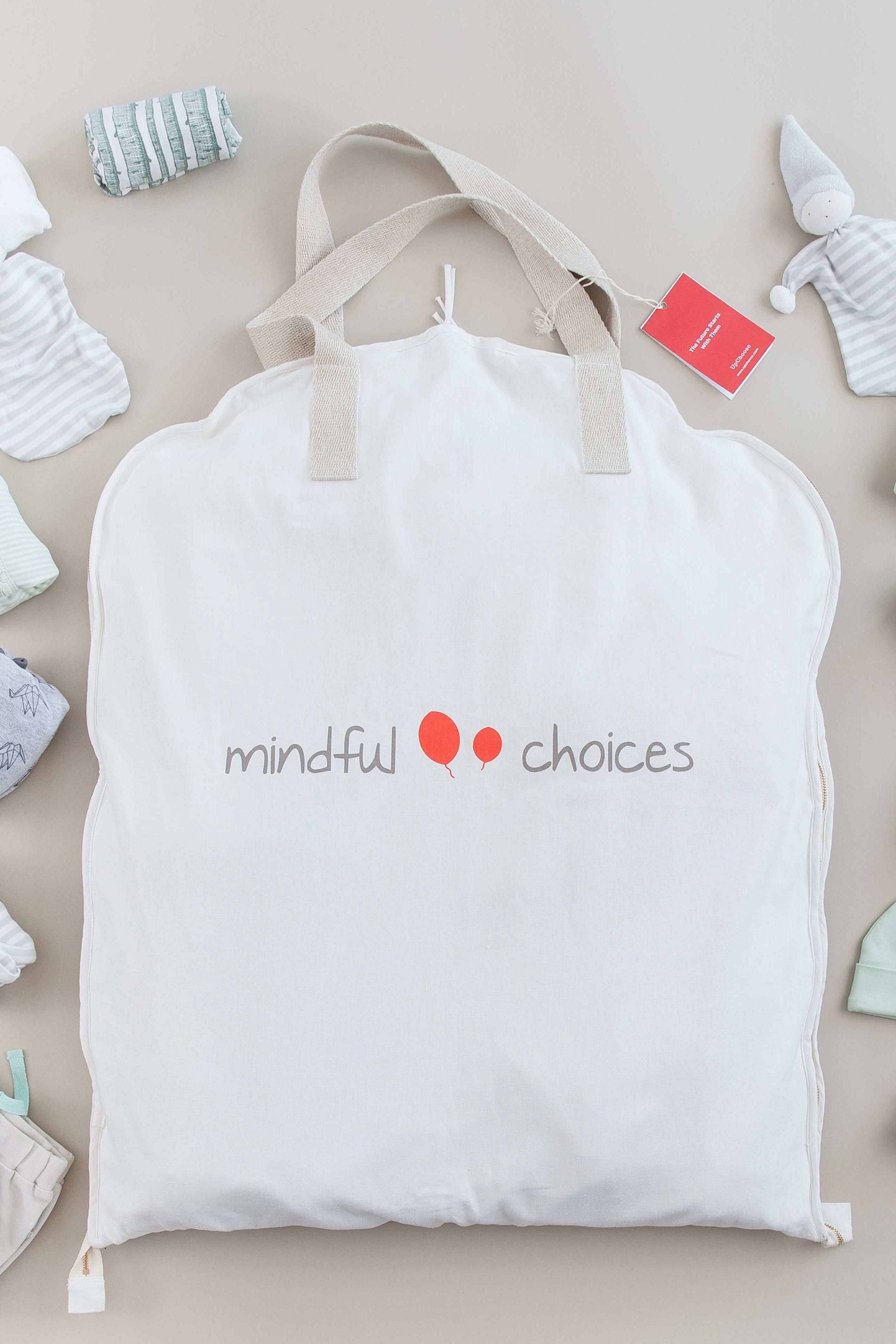 UpChoose Smart Storage Bag filled with a wardrobe of organic baby clothes